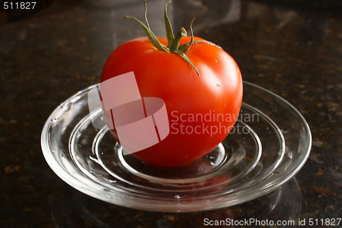 Image of Fresh tomato on the glass plate.