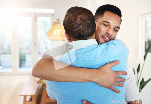 Image of Love, care and father and son with a hug for a visit, bonding and quality time. Happy, affection and dad hugging a man with an embrace after reunited, missing or showing appreciation in a home