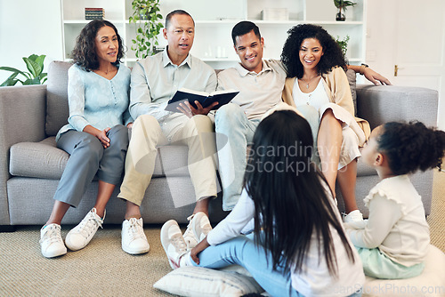 Image of Senior family, storytelling and children book, teaching and learning bible, spiritual development or education in living room. Grandparents, mother and father with kids reading holy story or language