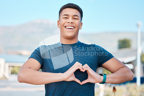 Image of Portrait, heart hands and fitness man for self care, cardiology and workout health support in outdoor running. Face of sports person or athlete with love emoji or sign in street training or wellness