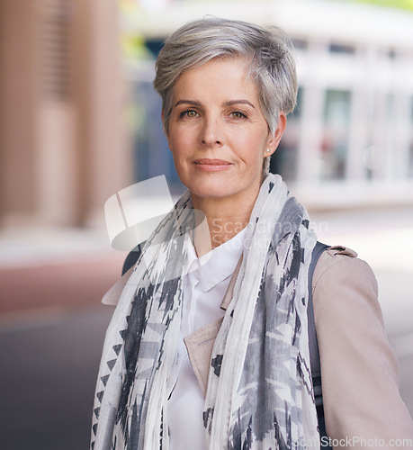 Image of Portrait, elderly and business woman confident in an urban town or city travel for a startup company. Adventure, mature and senior female traveling international with serious face for tourism