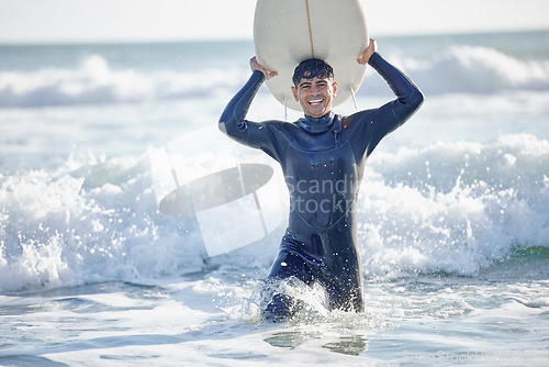 Image of Waves, surfing and man surfer with surfboard at the beach, sea or ocean with a smile and is happy on a summer day. Portrait, surf and male with swimsuit in Australia with freedom on vacation