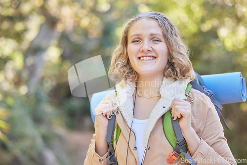 Image of Hiking, smile and portrait of woman with backpack, sun and freedom, hiker on trekking adventure in nature. Health, fitness and camping, happy face of gen z person on hike in mountain or forest of USA