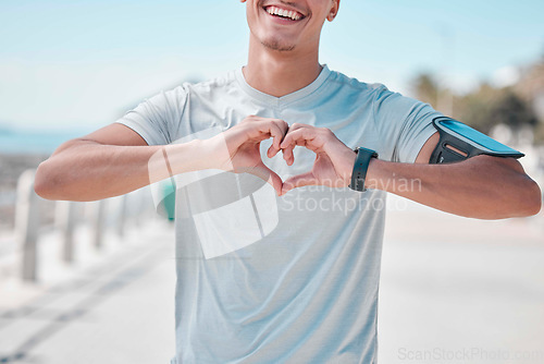 Image of Fitness, hands in heart and man with smile ready to start workout, training and cardio exercise. Sports, love and male runner with shape in Miami city for wellness, healthy lifestyle and motivation