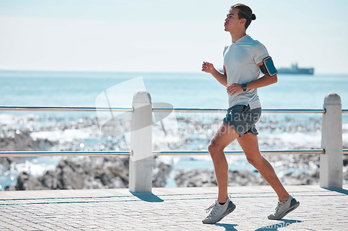 Image of Fitness, running and man by ocean for exercise, marathon training and endurance workout in action. Sports mockup, motivation and male runner focus for wellness, healthy body and performance in Miami