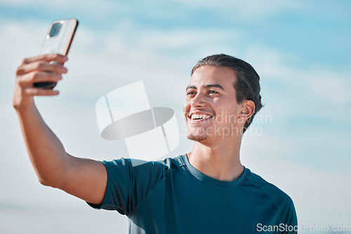 Image of Fitness, man and exercise selfie on outdoor for social media, profile picture and workout vlog post. Sports person, runner and photograph with smile on blue sky, wellness goals and running motivation