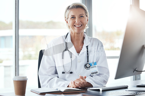 Image of Healthcare, medicine and portrait of a doctor at a desk for medical work, cardiology and surgery. Happy, working and mature woman consulting in medicare, hospital research and expert consultation