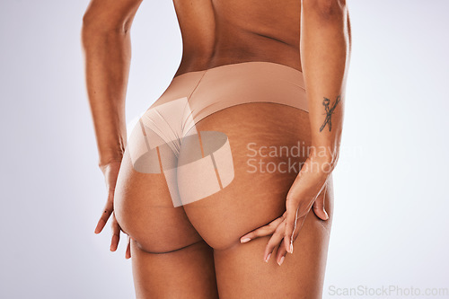 Image of Woman, butt and underwear in studio for cellulite skincare, dermatology spa or body wellness. Female beauty model, liposuction and ass in lingerie for hair removal, laser aesthetic or cosmetic health