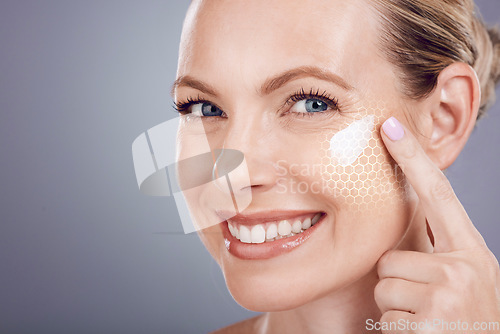 Image of Skincare, cream and portrait of woman with smile on gray background for wellness, cosmetics and facial. Beauty hologram, dermatology and girl face with crows feet, eye wrinkles and anti aging product