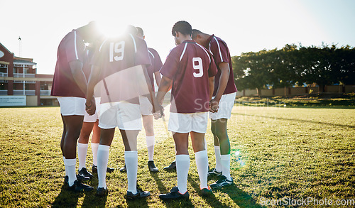 Image of Rugby, field or team in a circle praying for motivation, solidarity or support after sports training. Young men, fitness or group of male athletes in unity before a game or match on a grass stadium