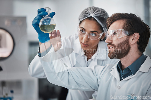 Image of Medical, team work or scientists in laboratory with chemical liquid after science research or scientific testing. Physics analysis, study or doctors checking acid solution for medicine development