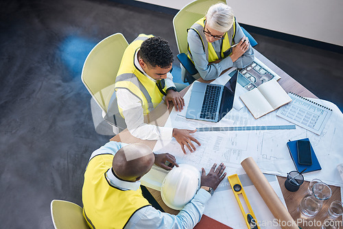 Image of Architect, laptop and team in meeting above for construction or building planning strategy at office. Group of diverse engineers discussing floor plan, project layout or blueprints for architecture