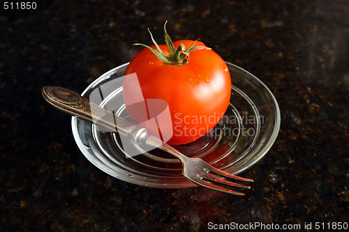 Image of Fresh tomato on the glass plate.
