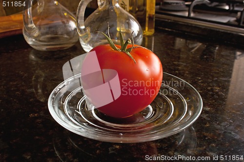 Image of Fresh tomato on the glass plate.
