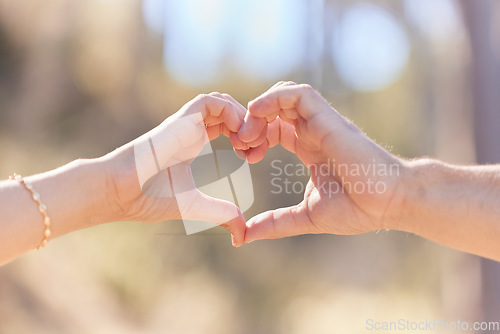 Image of Heart hands, nature and love, support and commitment partnership for marriage outdoors. Valentines day, romance and couple, man and woman with emoji for care, relationship and affection or trust.