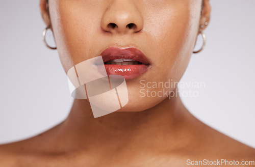 Image of Makeup, beauty and mouth of woman with cosmetics for wellness, self care and skincare in studio. Luxury spa, salon and face zoom of girl for facial treatment, lipstick and glamour on white background