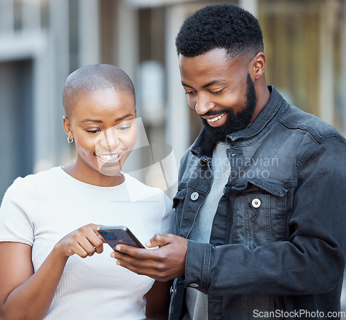 Image of City, communication and couple browsing on a cellphone with social media, mobile app or the internet. Technology, 5g network and young African man and woman scrolling on a website with phone in town.