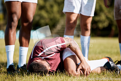 Image of Knee pain, sports with injury and athlete outdoor, rugby and fitness with man, team and first aid. Medical emergency, wound and sport accident, training and exercise with help and injured person