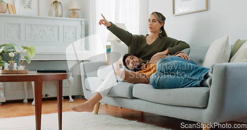 Image of Relax, love and watching tv with couple on sofa for movie, streaming or television subscription. Happy, smile and peace with man on woman legs in living room at home for video, news or film together