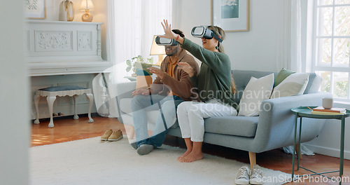 Image of Vr, virtual reality metaverse and couple on sofa in living room home exploring a virtual world, ai or cyber game. 3d future app, diversity and tech gaming man and woman playing software video games.