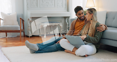 Image of Interracial couple, laptop and love being happy together, relationship and enjoy romance for planning date, talking and on floor home. Romantic, man and woman for bonding, embrace and relax with hug.