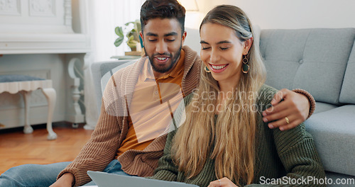 Image of Interracial couple, laptop and love being happy together, relationship and enjoy romance for planning date, talking and on floor home. Romantic, man and woman for bonding, embrace and relax with hug.