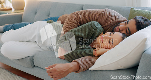 Image of Kiss, smile and couple sleeping on the sofa in the living room of their house together. Relax, happy and calm man and woman tired and cuddling on the couch in their home with affection and love