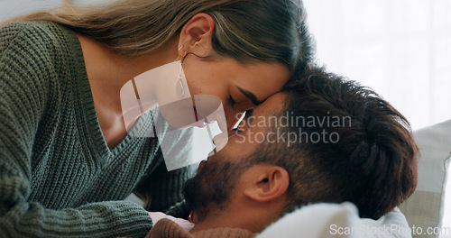 Image of Interracial, couple, love and kiss being happy, bonding and embrace for communication, talking together and at home. Romantic, man and woman with smile, intimate and being loving for romance or hug