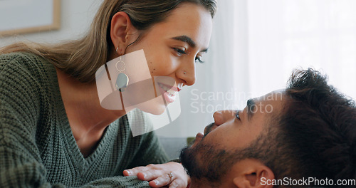 Image of Interracial, couple, love and kiss being happy, bonding and embrace for communication, talking together and at home. Romantic, man and woman with smile, intimate and being loving for romance or hug