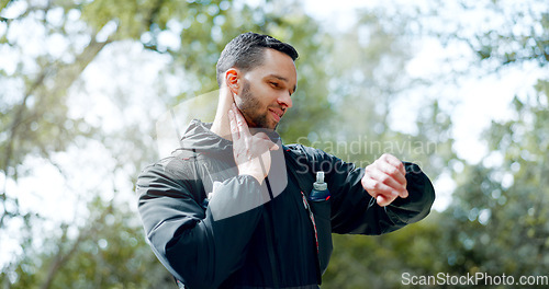 Image of Man checking pulse in neck, smartwatch with fitness app and hiking on adventure trail in forest. Nature, workout and exercise for healthy athlete in woods with 5g, heart rate tracker and motivation.