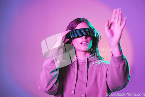 Image of Woman, vr and futuristic cyberpunk glasses on metaverse app for online game or video on neon purple background. Virtual reality, future fashion and digital augmented reality google on model in studio