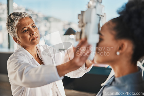 Image of Senior optometrist woman, eye exam patient and medical goal in hospital, consulting room and office with help. Elderly optician, eyesight test and phoropter for wellness, health and vision analysis