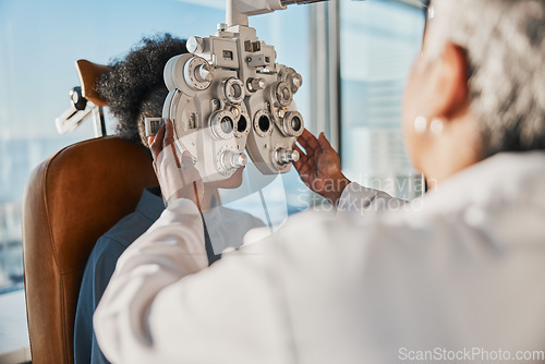 Image of Optometry, healthcare and optometrist doing a eye test for a patient for vision or eyecare in a clinic. Ophthalmology, medical and female optician doing exam for prescription lenses in optical store.