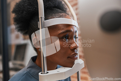 Image of Optometry, healthcare and woman doing eye test at a clinic for optic wellness, health and vision. Medical, ophthalmology and African female patient doing optical exam for prescription lenses in store