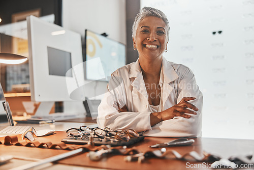 Image of Senior optometrist woman, portrait and office with glasses, smile or frame design planning at desk. Happy optician, spectacle designer and excited face in workplace for pride, small business and goal