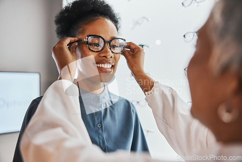 Image of Glasses check, black woman and customer with store worker and optician looking at lense. Eye consulting, smile and eyewear assessment in a frame shop for vision test and prescription exam for eyes