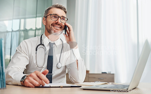 Image of Phone call, laptop and male doctor doing a telehealth consultation in his office in the hospital. Technology, communication and senior man healthcare worker on a mobile conversation in medical clinic