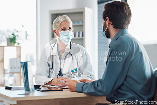 Image of Consultation, covid and doctor with a man for healthcare, medical attention and service. Medicine, support and consultant with a face mask for virus while talking to a patient about health results