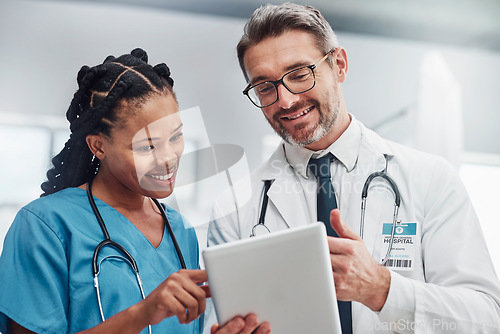 Image of Healthcare, research and doctors with tablet, conversation or data analytics in hospital. Medical professionals, black woman or man with device, discussion or search internet for cure or update chart