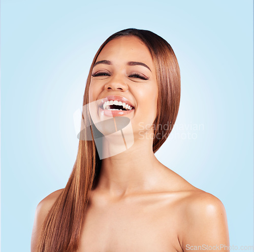 Image of Portrait, beauty and hair with a model black woman in studio on a blue background for natural haircare. Face, skincare and keratin with an attractive young female feeling proud of her hairstyle