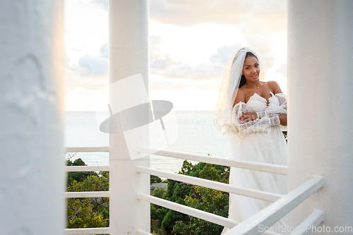 Image of Portrait of a bride in a wedding dress in a gazebo with columns on the seashore