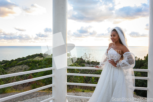 Image of Bride in a wedding dress in a gazebo with columns on the seashore