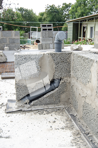 Image of Laying a sewer pipe in the wall during the construction of a house