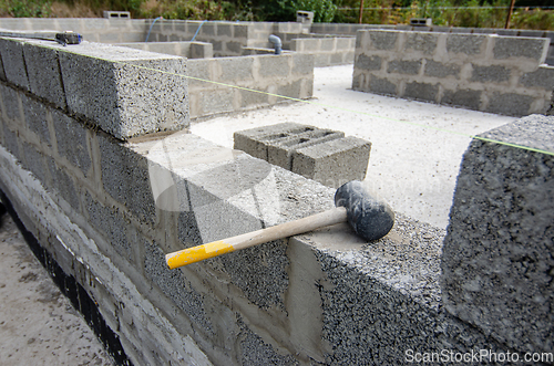 Image of Mallet lies on part of the wall during the construction of a residential building