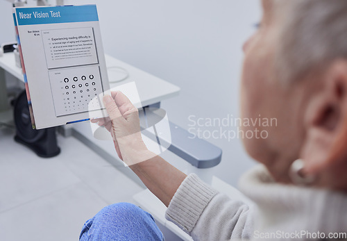 Image of Senior woman, eye exam and vision for snellen test for nearsighted problem at optometrist consultation room. Elderly patient, healthcare or paper for eyes, reading or eyesight in retirement at clinic