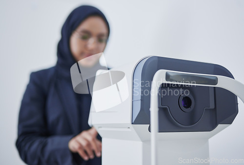 Image of Optometry, ophthalmology and Muslim woman with a machine for vision correction and surgery. Test, technology and optician with device for examination of eyes, optical measurement and visual exam