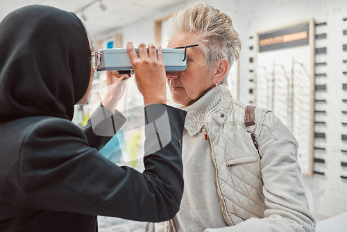 Image of Optometry, ophthalmology and Islamic optometrist doing eye exam on senior woman or patient in Dubai for eyecare. Medical, doctor and muslin professional doing vision or eyesight examination