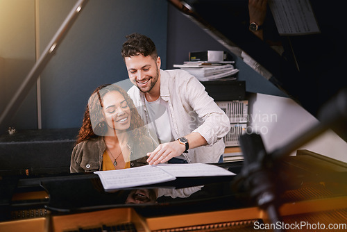 Image of Musicians, piano and people writing music in a creative or recording studio with a song book. Art, creativity and couple in production of album or sound track together with a musical instrument.