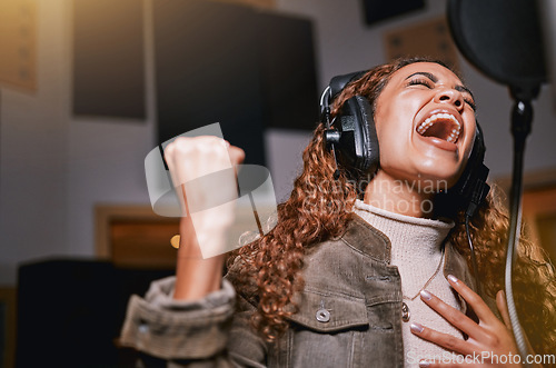 Image of Music, singing and recording studio with a black woman celebrity at her record label to sing a song for her new album. Creative, art and performance with a female singer streaming live on the radio