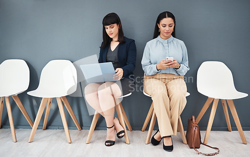 Image of Waiting room, interview and women ready for hiring meeting with laptop and phone in office building. People, employee and worker preparing for business internship or job opportunity or employment